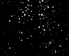 Splashes of white milk isolated on a black background.