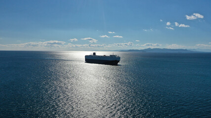 Aerial drone photo of Large RoRo (Roll on-off) car transportation vessel cruising the Mediterranean deep blue sea