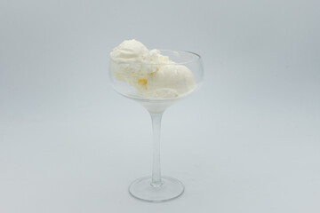 Vanilla ice cream without any topping in glass on white background.