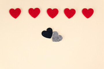 Hearts on pastel peach colors. Red, grey and black hearts. Valentines Day background. Valentine's Day concept. Flat lay.