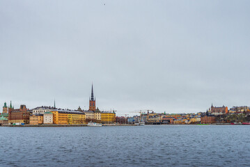 Fototapeta na wymiar A panoramic view on shoreline in Stockholm from Stadshusparken view point on a cloudy winter day