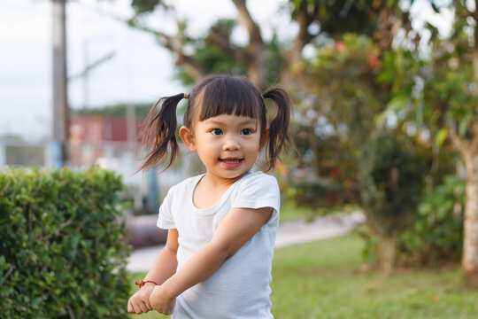 Portrait image of 2-3 years old of toddler baby girl. Happy Asian child playing with the toy at the park playground. Learning and kid concept.