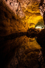 Cave reflection lava tube illuminated in Canary Islands. Geological cavern formation, tourist attraction concepts