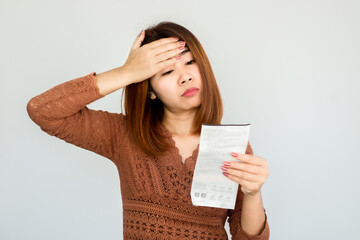 stressed Asian woman shocked with number on electricity bill ,invoice having problem with payment