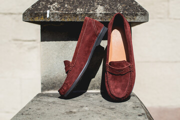 Brown leather moccasins. Photo on the street on the wall. Trendy brown loafers.