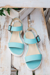 Fototapeta na wymiar Pair of female summer blue sandals. Concept art women's shoes. style footwear.
