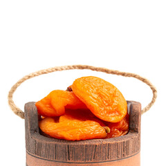 Dried apricots fruit in a bowl, isolated on white background, close up view