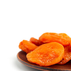 Naklejka na ściany i meble Dried apricots fruit in a plate, isolated on white background, close up view