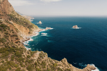 View of an empty rocky coastline, azure sea, mountain and rocks, Turkey