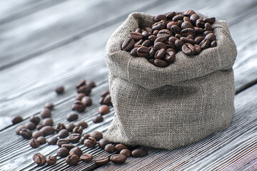 Coffee in a canvas bag for festive decoration. Coffee beans close-up. In anticipation of a fragrant drink.