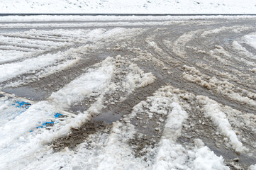 Slushy snow melting on the road.