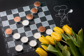 chessboard with a bouquet of flowers and candles. Romantic setting on March 8