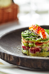 Salad of avokado, seafood, meat, vegetables and pumpkin seeds. Dietary, wholesome and tasty. Banquet festive dishes. Gourmet restaurant menu. White background.