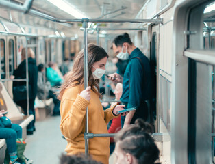 variety of passengers ride the subway car
