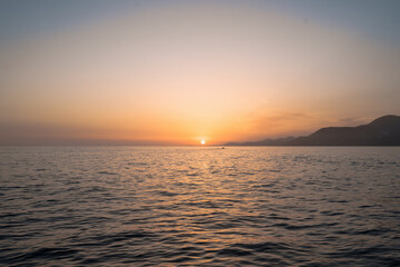 Beautiful sea with sunset sky and sun through the clouds over. Meditation ocean and sky background. Tranquil seascape. Horizon over the water.