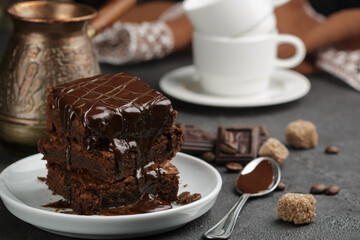 Delicious homemade brownie with chocolate sauce and caramel on the table. Selective focus