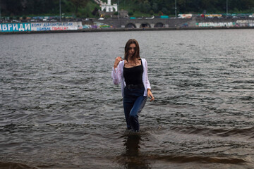 Young woman dressed black and white wet 