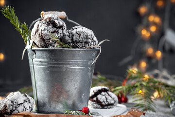 Freshly baked sweet chocolate chip cookies on a baking sheet. Sprinkle the cookies with icing sugar. Brownie close up