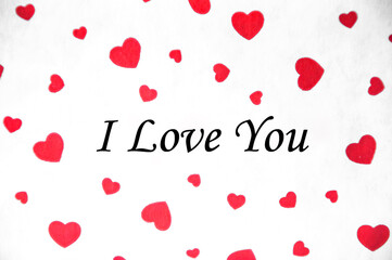 red hearts on white. texture with romantic hearts. the inscription on the image I love you. this photo illustrates the festive atmosphere.  valentine's day concept