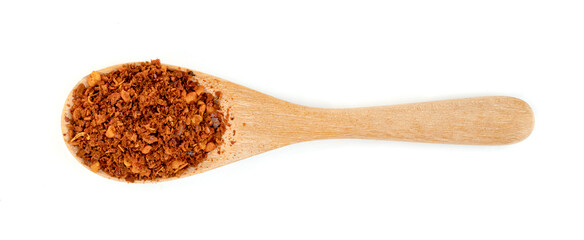 red ground paprika powder or dry chili pepper with wooden spoon isolated on white background