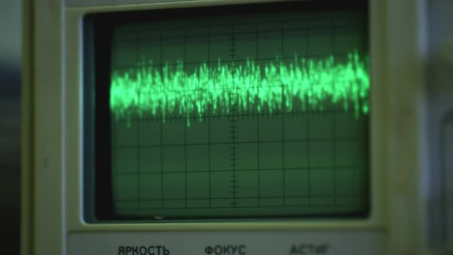 Oscilloscope wave on analog screen. Military tracking monitor. Amplitude Diagram on the oscilloscope.