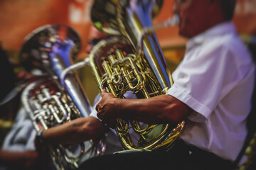 Concert view of an jazz orchestra tubist Tuba player performs with musical jazz band and audience...