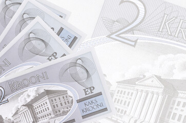 2 Estonian kroon bills lies in stack on background of big semi-transparent banknote. Abstract...