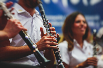 Fototapeta premium Concert view of an jazz orchestra tubist Tuba player performs with musical jazz band and audience in the background on open air concert