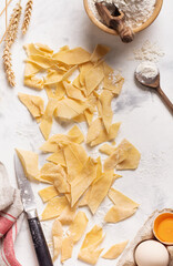 Baking background with cooked Homemade and freshly made pasta Maltagliati. Traditional Italian food. Cooking concept. Top view.