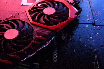 Computer game graphics card, videocard with two coolers on circuit board ,motherboard background....