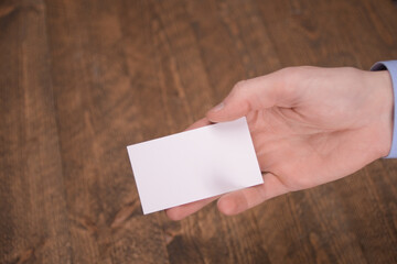 Hand hold blank white card mockup with rounded corners. Plain call-card mock up template holding arm. Plastic credit namecard display front. Check offset card design. Business branding.