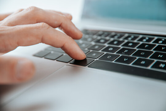 close up. man pressing the command key on his laptop.