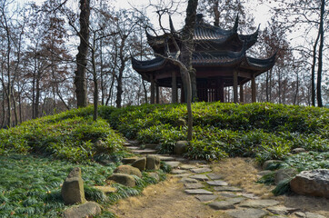 Tiger hill's shelter at a grassy hill. Suzhou, China.