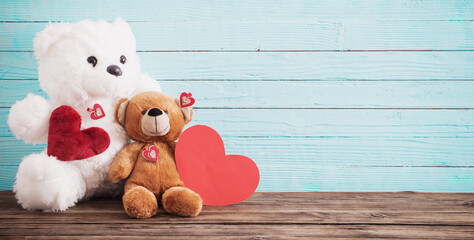 Teddy bear with red heart on old wooden background. Valentine's day concept