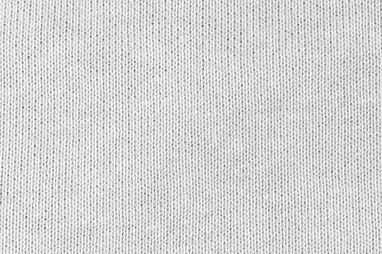 White natural texture of knitted wool textile material background. White cotton fabric woven canvas texture