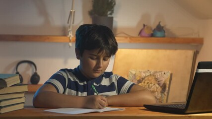 Boy prepares homework and stretches in his room at home