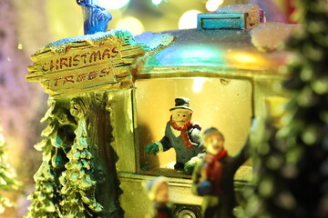 Fototapeta premium Small miniature village with Christmas trees shop, people, xmas time