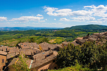 Fototapeta na wymiar The late summer landscape around Montepulciano in Val d'Orcia, Siena Province, Tuscany, Italy. Seen from above the town's rooftops 