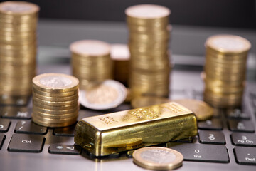 money coins on laptop computer