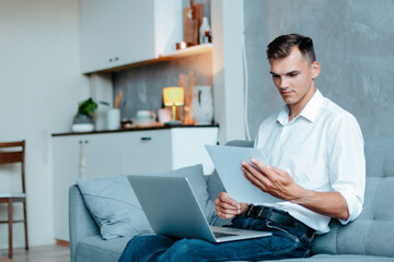 entrepreneur works with documents in his apartment .