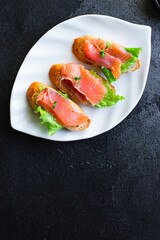sandwich salmon fish bruschetta with seafood antipasto aperitif ready to eat on the table for healthy meal snack outdoor top view copy space for text food background image rustic diet pescetarian
