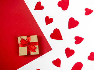 Gift and red hearts on a red and white background.Valentine's Day.
