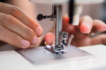 hand working with sewing machine
