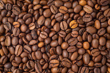 Roasted coffee beans covering the entire picture, creating a nice background.