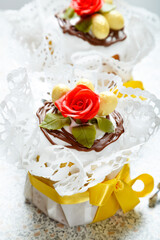 Easter cakes with chocolate eggs on white wooden table background. Holiday celebration. Traditional festive meal and dessert.