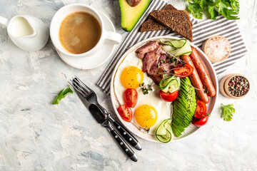 Traditional English Breakfast with fried eggs, sausages, beans, avocado and bacon, cup of fresh coffee on white background. banner, catering menu recipe place for text, top view.