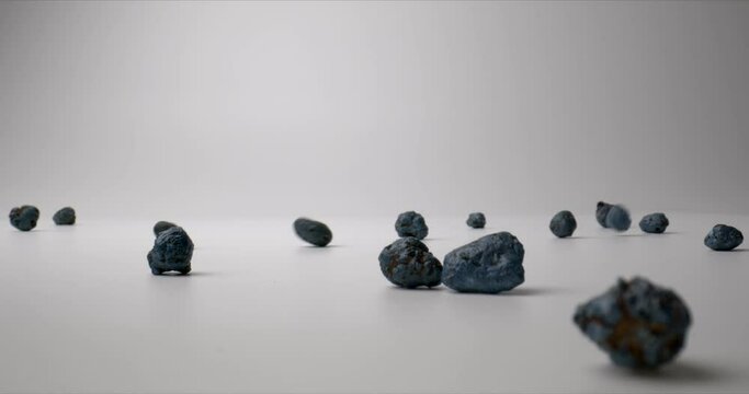 Falling expanded clay (exclay) on white background. Planting home plants. Close up. High quality.