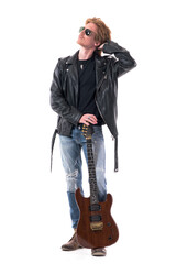 Naklejka premium Handsome stylish rocker man looking up for music inspiration with hand in hair. Full body isolated on white background. 