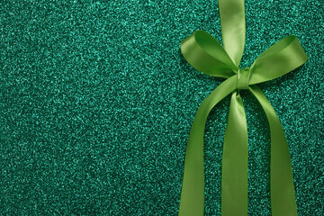 Green gift shiny card or texture gift box with ribbon bow. St Patricks Day concept, birthday,...