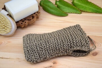 Twine scrubbing sponge, natural jute body washcloth, zero waste concept, eco-friendly bath, crochet jute twine handmade on wooden background